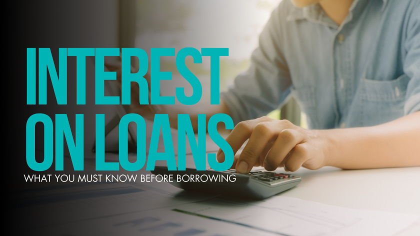 A financial-themed graphic with the bold headline “Interest on Loans” in bright turquoise text, followed by the subtitle “What You Must Know Before Borrowing.” In the background, a person in a casual button-down shirt is using a calculator at a desk, suggesting they are reviewing finances or calculating loan costs. The scene is softly lit with a window in the background, creating a calm, thoughtful atmosphere focused on financial decision-making.
